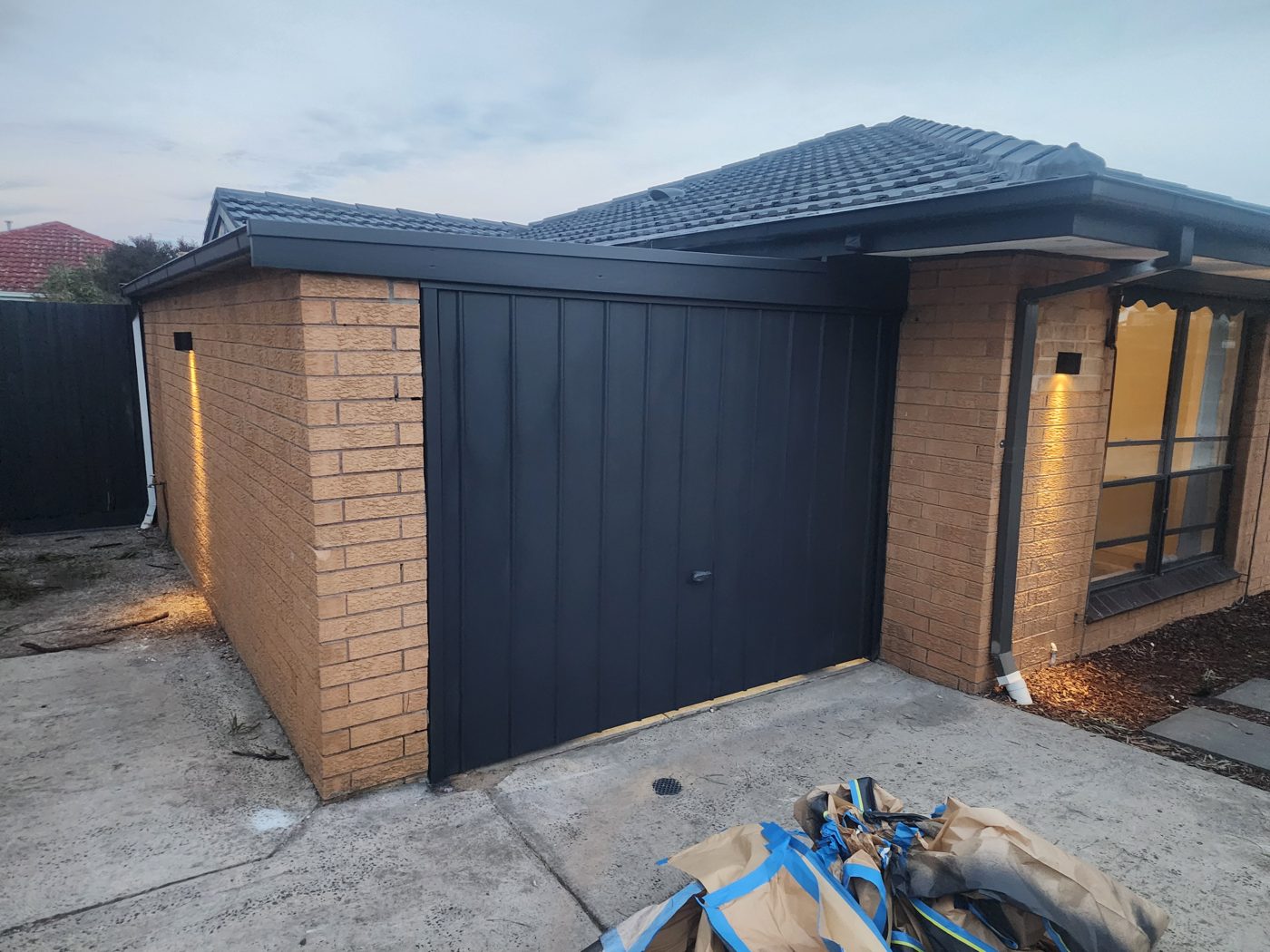 Exterior painting — black feature doors and trim