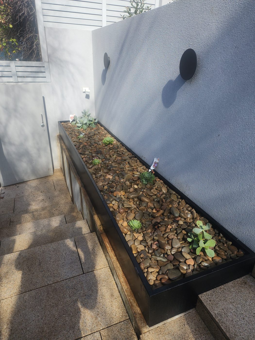 Feature planter — Pebbles and small plants